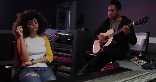 Band working on a track together in a recording studio