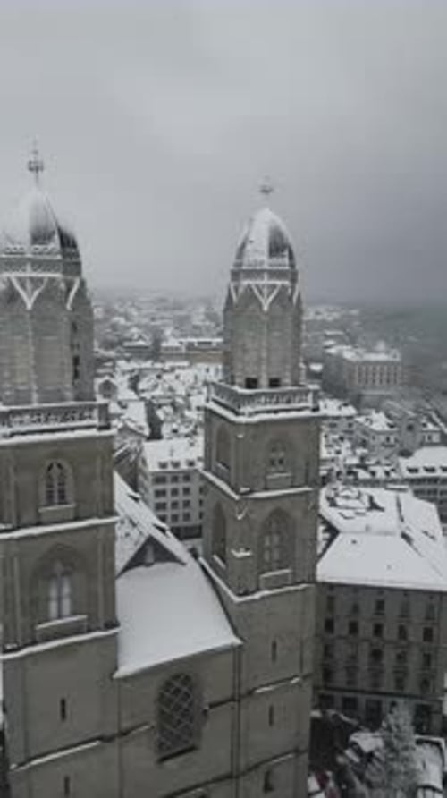 Aerial video of the steeple at the Grossmunster church in Zurich, Switzerland in winter