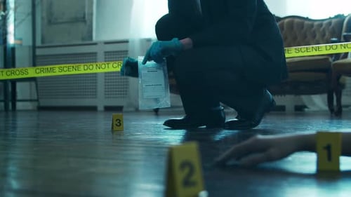 Gloved Investigator Crouches at Crime Scene
