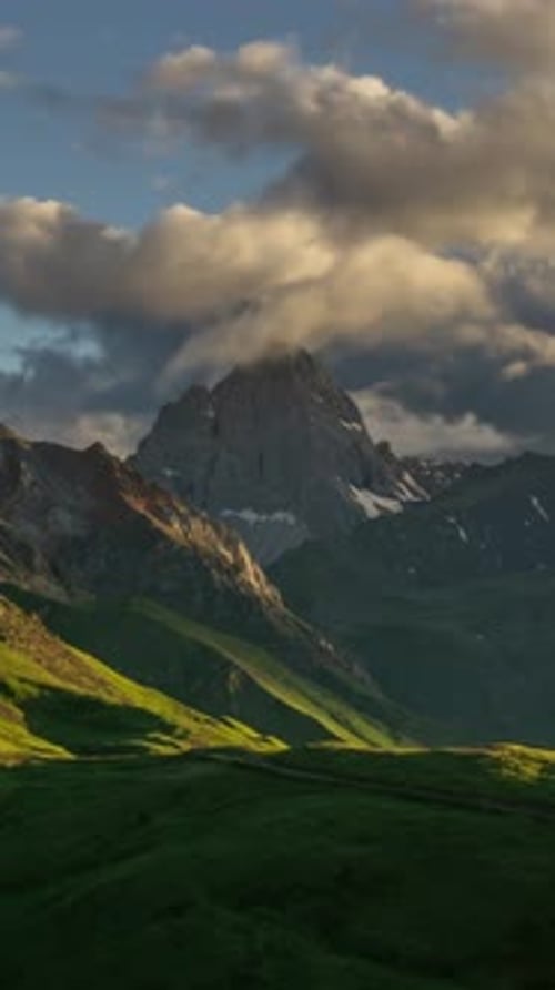 Majestic Mountains and Sweeping Clouds at Sunrise