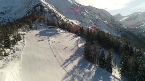 Picturesque high view over alpine ski trail in wintertime. Picturesque canopies of alpine trees. Win