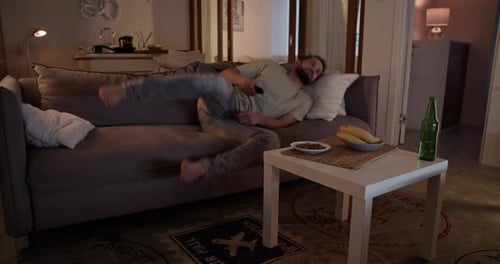 Bearded Man Relaxing on Couch Falls Asleep