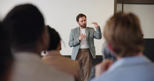 Speech, man and discussion with audience in seminar for coaching, learning or corporate improvement