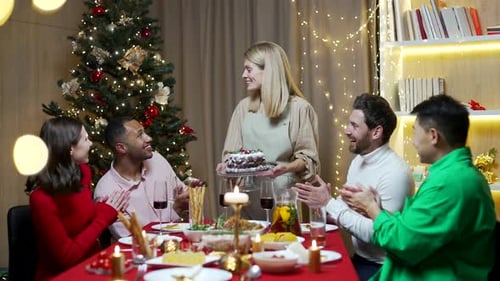 Friends Celebrating Christmas with Cake and Dinner