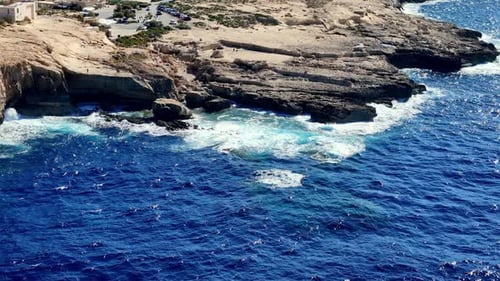 Rocky Shoreline and Deep Blue Sea from Above