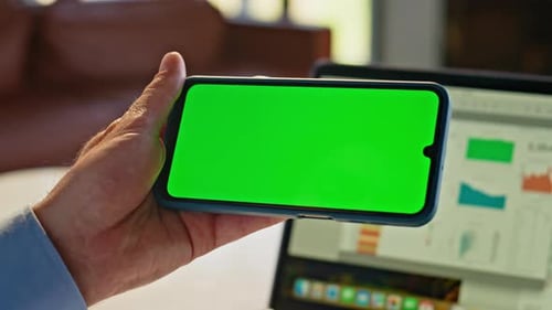 Hand Holds Phone With Green Screen