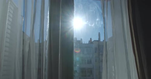 Sunlight Through Window Curtains in Urban Home