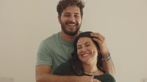 Happy Couple Embracing and Smiling at Each Other