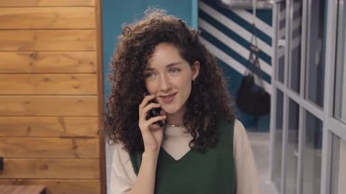 Young Woman Having Personal Phone Call at Work