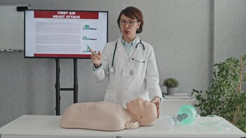 Medical Professional Giving First Aid Lecture with Dummy