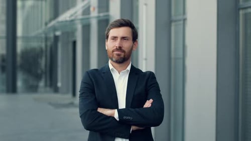 Outdoor Portrait of Confident Middle Aged Businessman Standing Outdoors with Folded Arms Posing Near