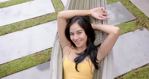 Woman Relaxing in Hammock on Sunny Day