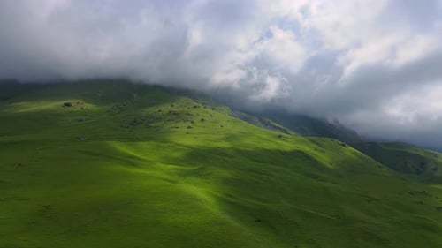 Misty Mountainous Landscape with Green Hills Cloudy Skies and a Serene View of Natures Beauty