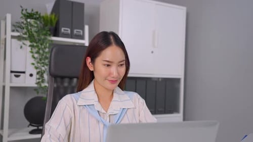 Asian beautiful businesswoman using laptop computer working in office.