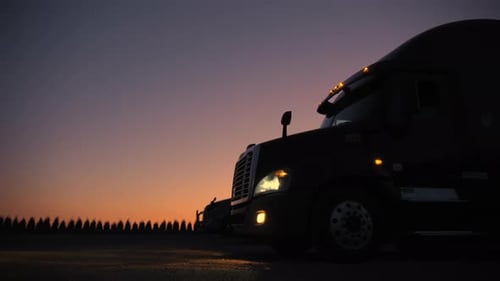 Parked Semi-Trucks Await Dawn Departure
