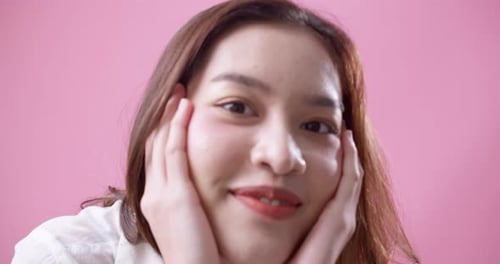 Beautiful Woman Smiling and Posing in Front of Pink