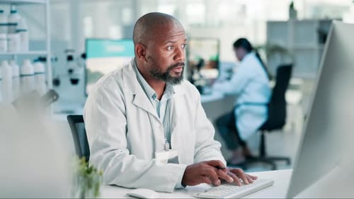 Scientist Working Diligently in a Bright Laboratory