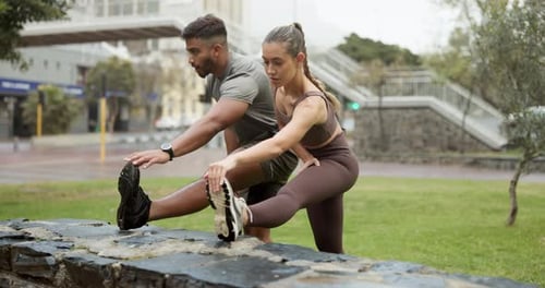 Couple Stretching Legs in Urban Park