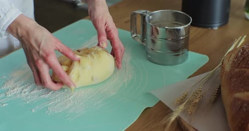 Person Kneading Dough Ball on Kitchen Counter