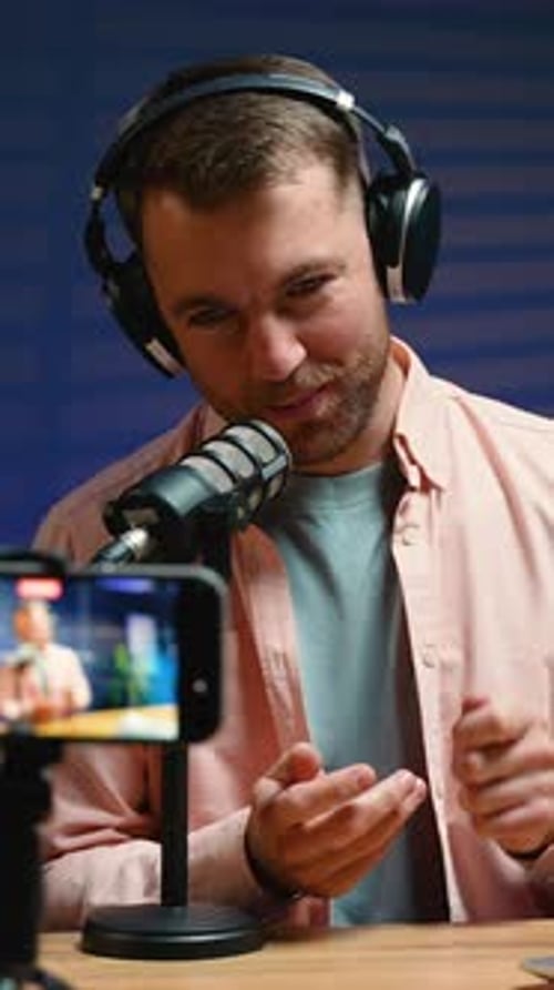 Man Recording Podcast into Microphone at Home