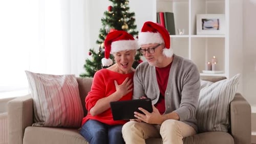 Senior Couple Video Calling on Tablet During Christmas