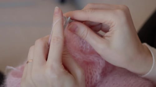 Woman's Hands Knitting a Pink Mohair Wool Scarf
