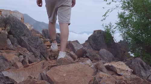 Close Up Of Male Hiker's Legs Hiking To The Top Foggy Mountain