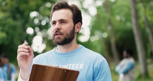 Clipboard, planning and man volunteer outdoor with social responsibility, ngo or charity event