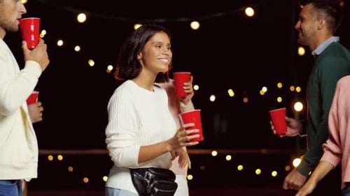 Friends Having Fun at an Outdoor Party at Night