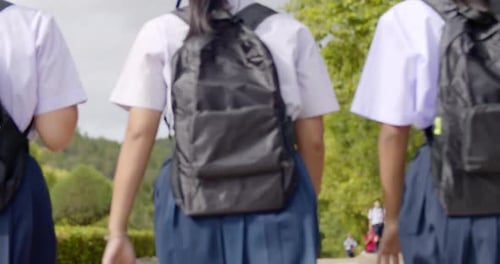 A group of happy Asian high school student girls in white uniform are going back to school