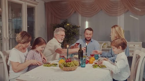 Family Sharing a Meal and Celebrating Together
