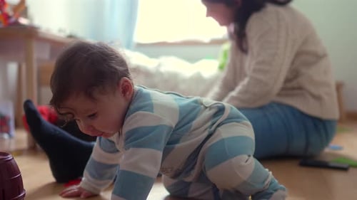 Adorable Baby Playing with Toys on Hardwood Floor