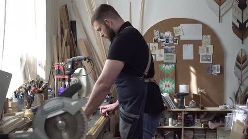Portrait of a Male Carpenter in a Carpentry Workshop While Working