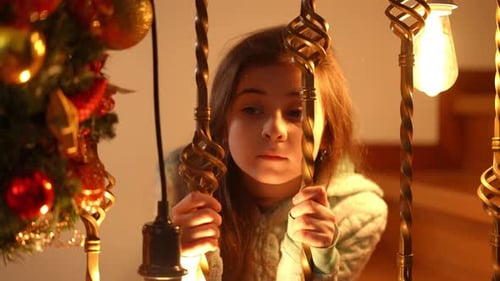 Girl Looking Through Railing near Christmas Tree