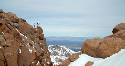 Couple on Top of Rocky Mountains, Close Up View From Peak Adventure