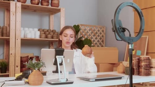 Woman Records Video Reviewing Wooden Handmade Vases