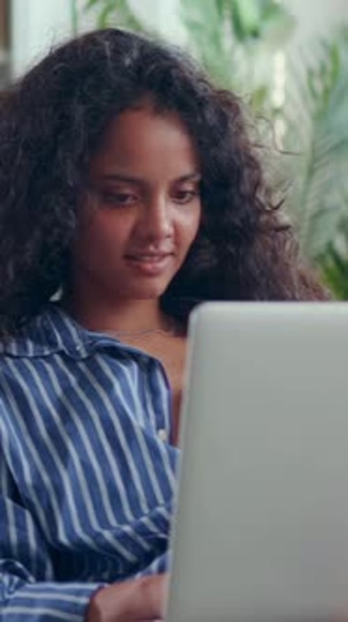Young Attractive Focused Indian Woman Student Working with Laptop