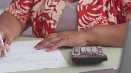 Filing Tax Forms with Calculator at Table