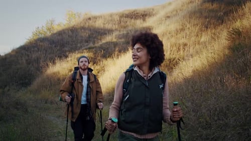 African American Woman with Boyfriend Walks in Valley with Hills