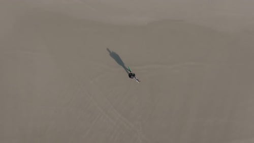 Surfer With Surfboard Walking On Sandy Beach In A Laracha, Coruna, Spain. aerial, slow motion