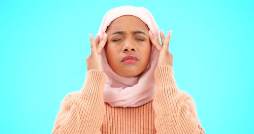 Muslim woman, headache and pain in studio for depression, stress and burnout