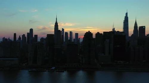 long slow epic trucking shot of the legendary Midtown Manhattan skyline at gorgeous dusk sunset