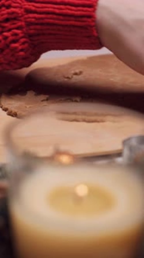 Hands Cutting Christmas Cookies with Star Cookie Cutter