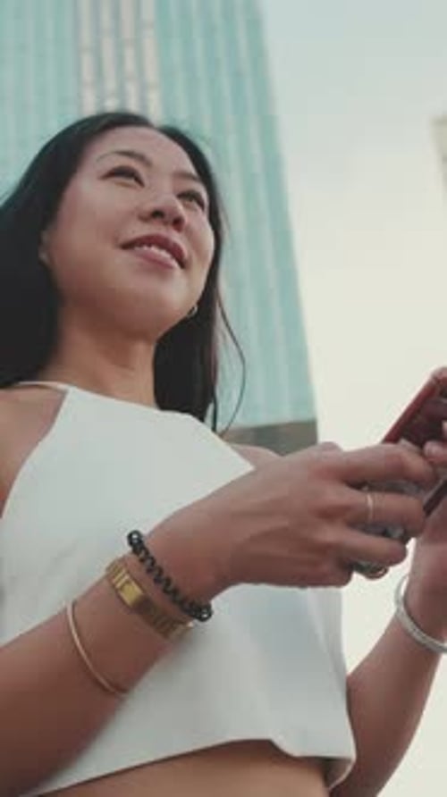 Stylish Woman Using Phone in City