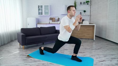 Young Adult Man Doing Lunges at Home
