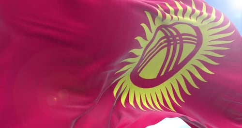 Realistic Kyrgyzstan Flag Waving in Wind with Blue Sky Background