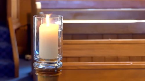 Shot of lighted candles used for prayers in memorial wedding funeral services in a religious church