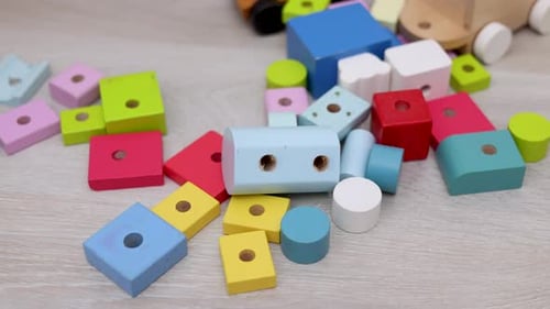 adorable baby boy child playing at home floor with wooden building block set,pyramid puzzle,