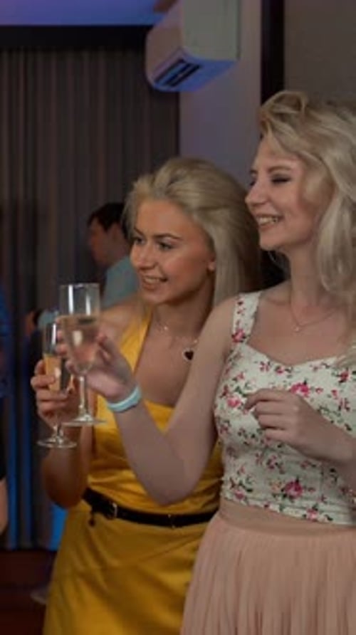 Young Women Celebrating at a Party with Champagne