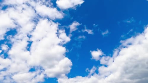 Clouds Drifting Slowly Across Bright Blue Sky